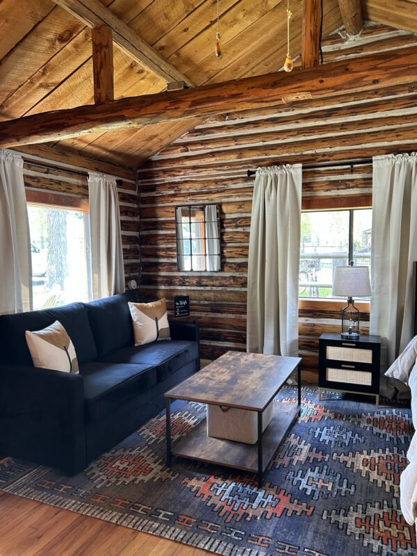 A living room in the Alpine Standard Cabin #3 with a couch and coffee table.