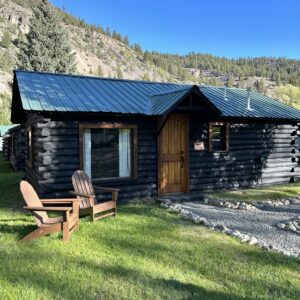 An Alpine Standard Cabin #10 in the middle of a grassy area.
