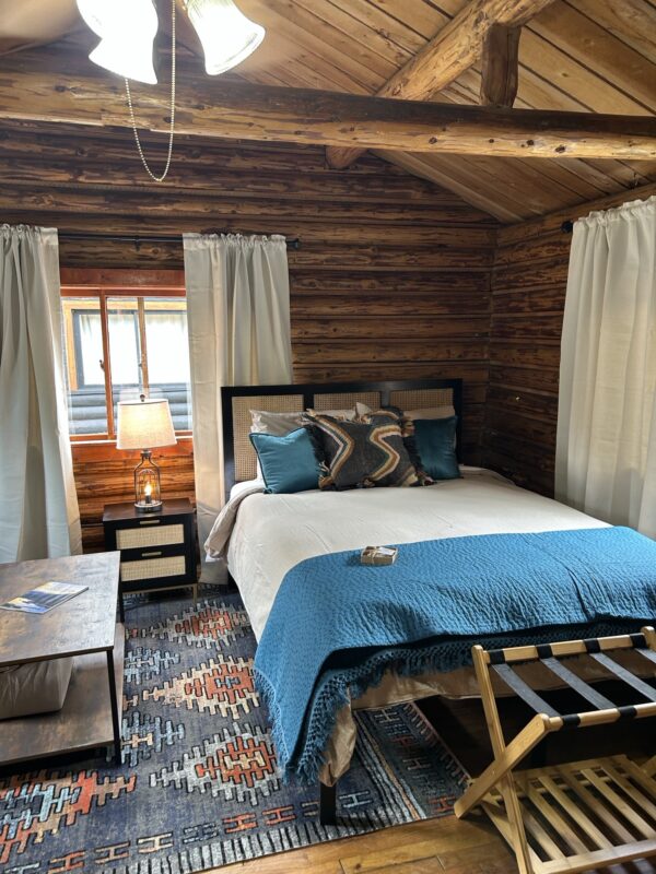 An Alpine Standard Cabin #2 with a bed and a bedside table.